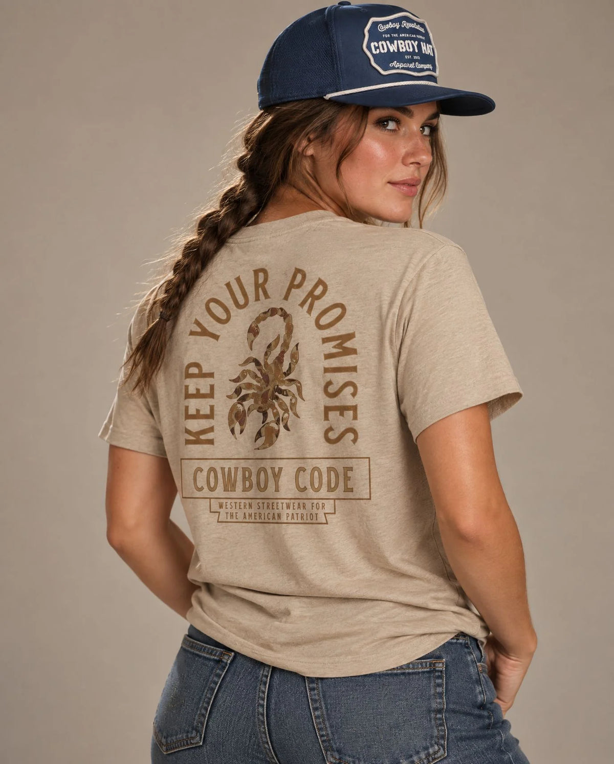 Female model in Cowboy Code No. 6 Keep Your Promises tee, Tan and Navy rope hat, Cowboy Revolution