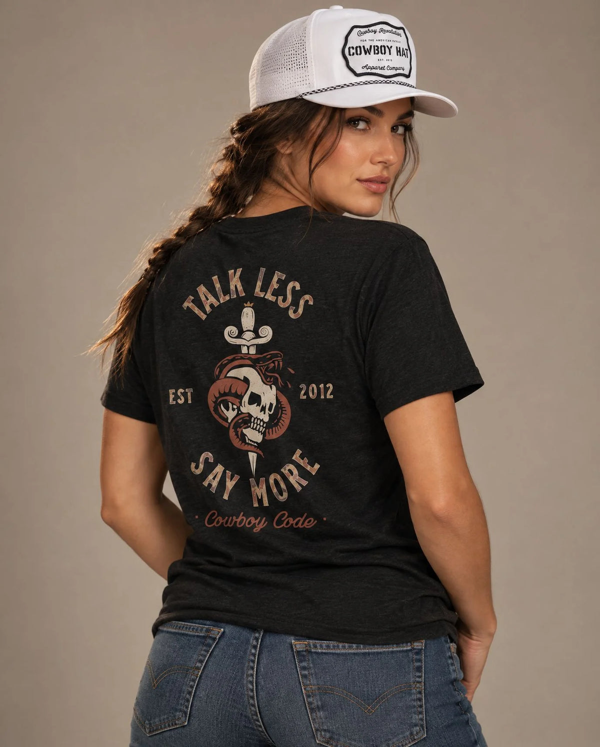 Female model in Cowboy Code No. 8 Talk Less, Say More tee, Solid Black and White rope hat, Cowboy Revolution
