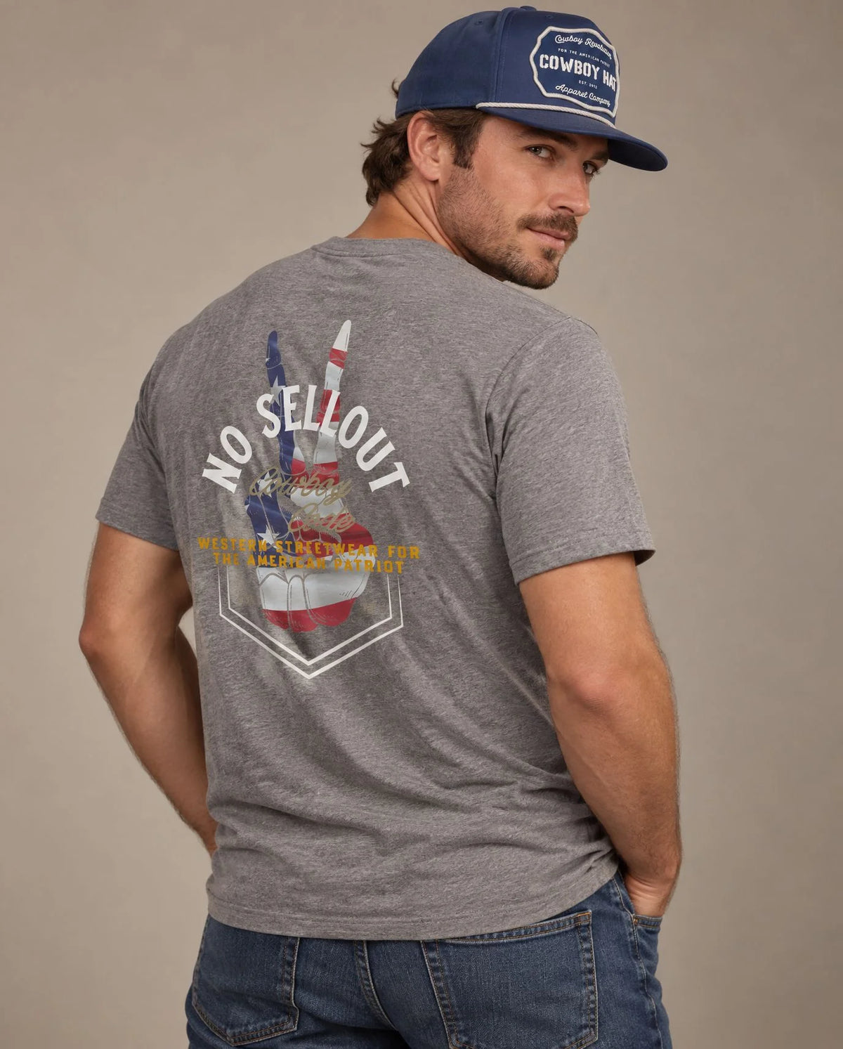 Male model in Cowboy Code No. 9 No Sellout tee, Grey and Navy rope hat, Cowboy Revolution