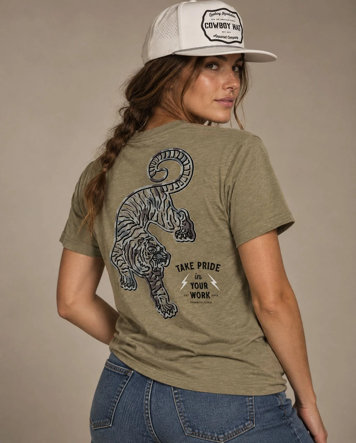 Female model in Cowboy Code No. 2 Take Pride in Your Work tee, Olive and White rope hat, Cowboy Revolution